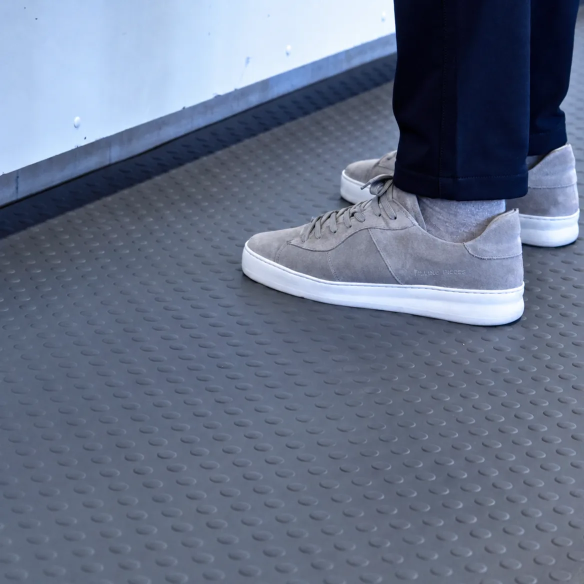 Close-up of shoes on an M2 grey bubble anti-fatigue mat