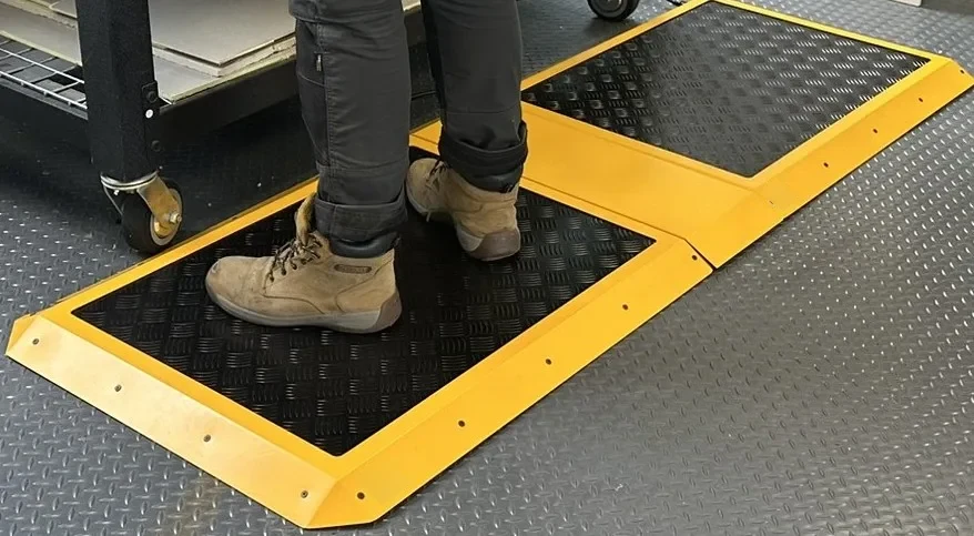 Two M-Heat heated mats joined by a safety connector at a workbench